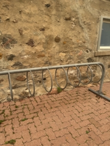 This rack is in front of the washrooms attached to the Dandelion Cafe on the side facing the visitor centre! a bike rack near the Dandelion Cafe at Toronto Botanical Garden
